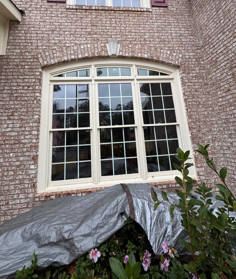 Before: arched window in a brick wall