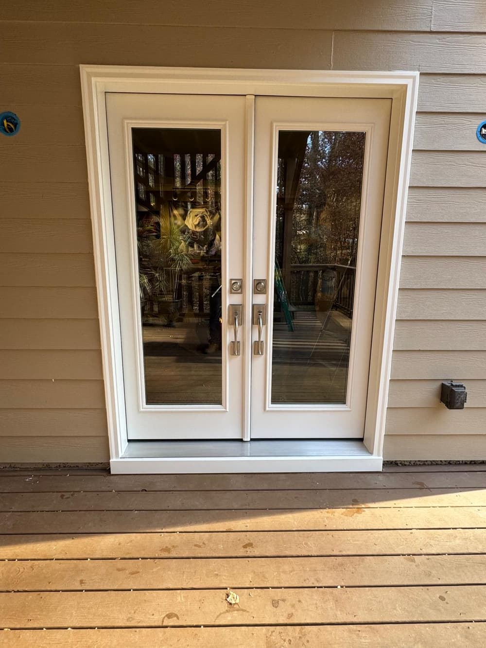 White French patio doors with full glass on a back deck